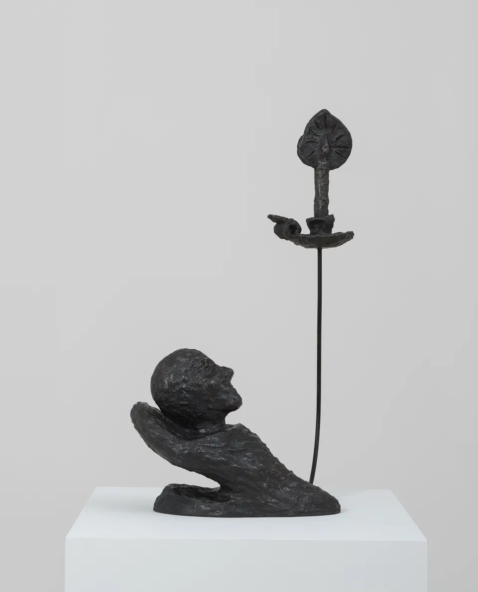 Andrew Lord, head resting with one candle